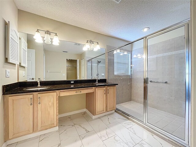 full bathroom with a shower stall, marble look tiles, double vanity, a textured ceiling, and a chandelier