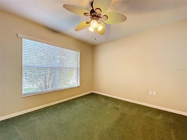 empty room with dark carpet, baseboards, a textured ceiling, and ceiling fan