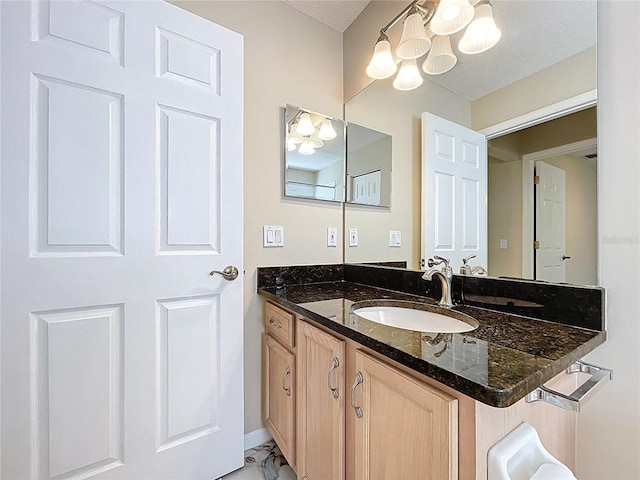 bathroom featuring a chandelier and vanity