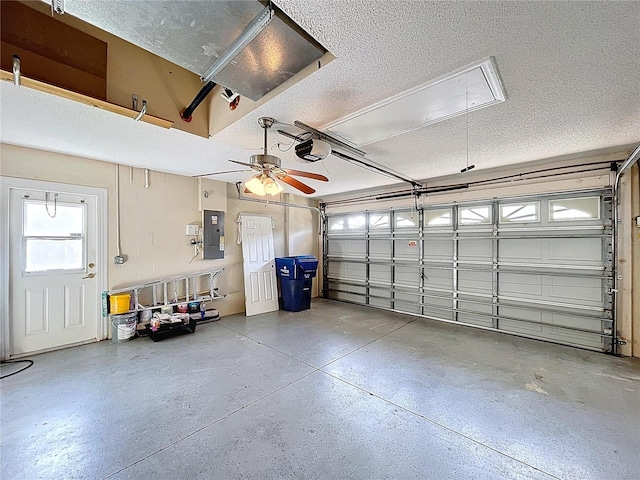 garage with electric panel and a garage door opener