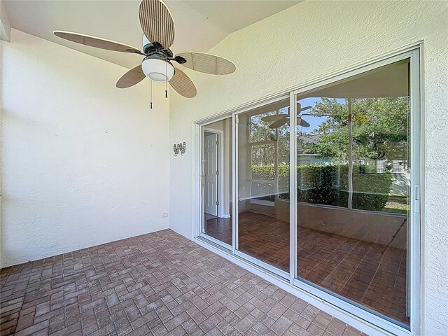 unfurnished sunroom with ceiling fan and plenty of natural light