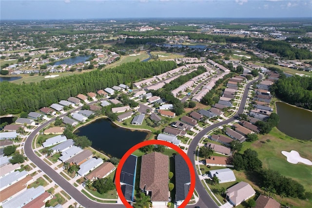 aerial view of property's location featuring a large body of water, nearby suburban area, and a local golf course