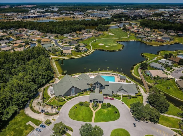 aerial view of property and surrounding area featuring a large body of water and nearby suburban area