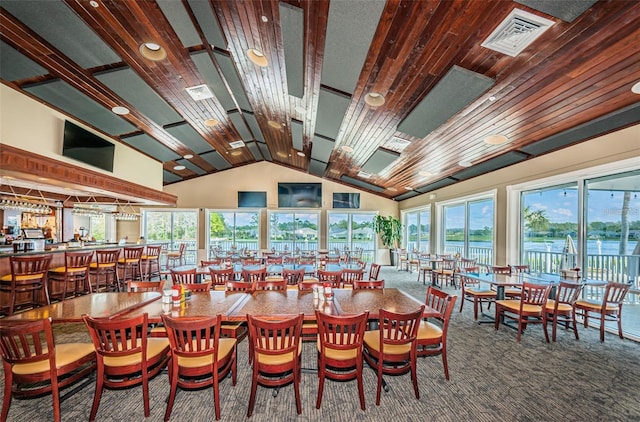 dining area featuring carpet floors and lofted ceiling