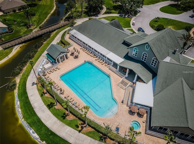 bird's eye view of a pool and a nearby body of water
