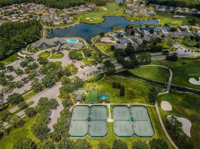 view of property location featuring nearby suburban area, a nearby body of water, and a golf course