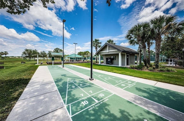 view of property's community with a yard and shuffleboard