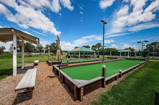 surrounding community featuring a bocce ball area, a gazebo, and a yard