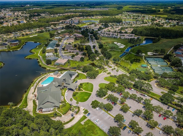 aerial overview of property's location with a nearby body of water, nearby suburban area, and a golf course