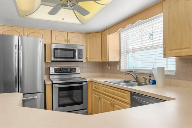 kitchen featuring a sink, light brown cabinetry, and stainless steel appliances