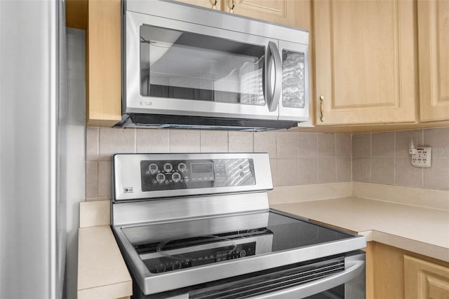 kitchen featuring light countertops, stainless steel appliances, decorative backsplash, and light brown cabinets