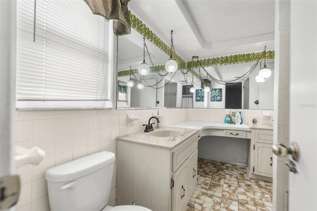 bathroom featuring vanity, decorative backsplash, and toilet