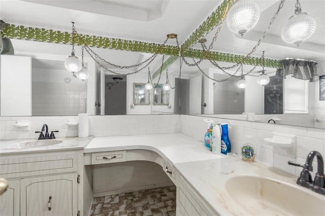 full bath featuring vanity and tasteful backsplash