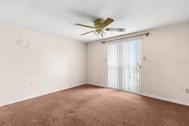 unfurnished room with baseboards, ceiling fan, carpet, and a textured ceiling