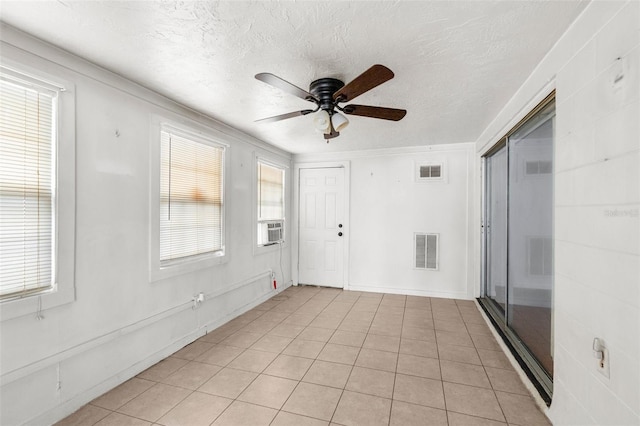 entryway with visible vents, a ceiling fan, a textured ceiling, and a wealth of natural light