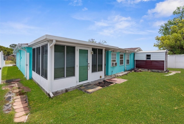 back of house with fence, a yard, a sunroom, and cooling unit