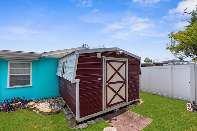 view of shed featuring fence