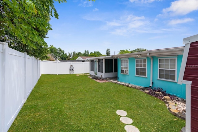 view of yard featuring a fenced backyard and a sunroom