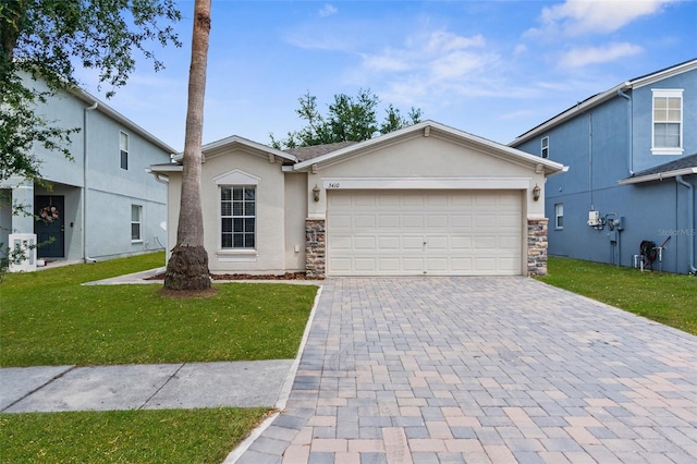 3410 Thistledown Ln, Land O Lakes, FL 34638 - ranch-style house with stone siding, stucco siding, decorative driveway, and a front yard