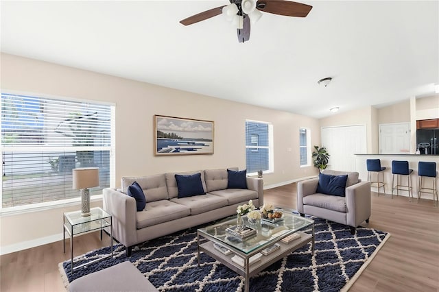 3410 Thistledown Ln, Land O Lakes, FL 34638 - living room featuring baseboards, a healthy amount of sunlight, ceiling fan, and vaulted ceiling