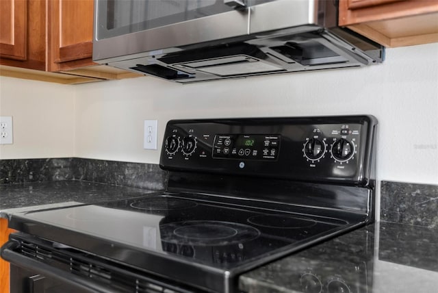 3410 Thistledown Ln, Land O Lakes, FL 34638 - details with stainless steel microwave, black electric range, and brown cabinetry