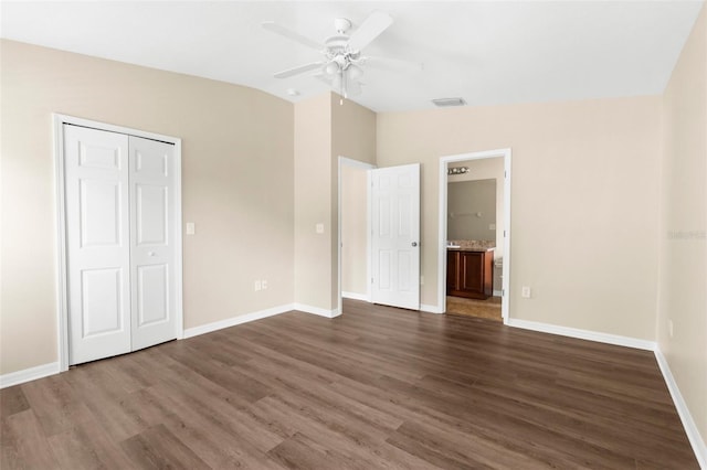 3410 Thistledown Ln, Land O Lakes, FL 34638 - unfurnished bedroom with vaulted ceiling, dark wood-style flooring, baseboards, and visible vents