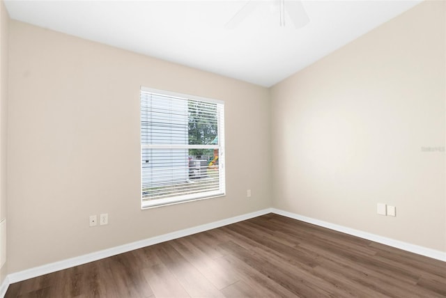3410 Thistledown Ln, Land O Lakes, FL 34638 - empty room featuring baseboards, dark wood-style flooring, and a ceiling fan