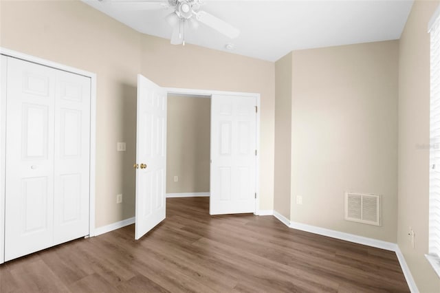 3410 Thistledown Ln, Land O Lakes, FL 34638 - unfurnished bedroom featuring a closet, wood finished floors, visible vents, ceiling fan, and baseboards