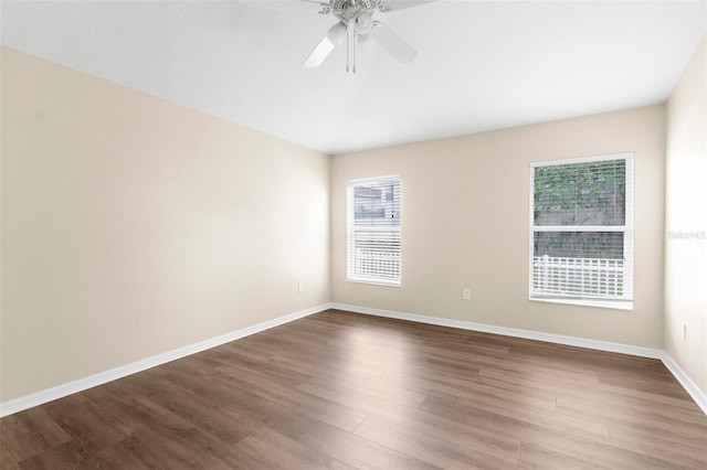 3410 Thistledown Ln, Land O Lakes, FL 34638 - spare room featuring dark wood-style flooring, baseboards, and ceiling fan