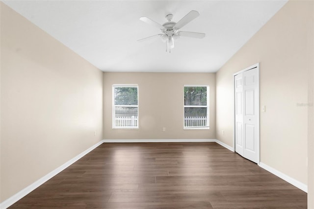 3410 Thistledown Ln, Land O Lakes, FL 34638 - unfurnished bedroom with baseboards, dark wood-style flooring, a closet, and ceiling fan