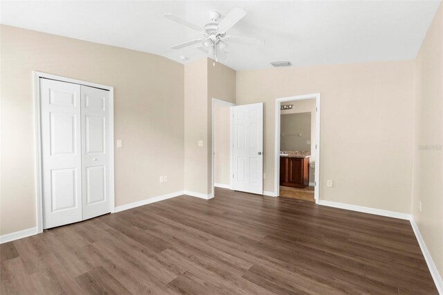 3410 Thistledown Ln, Land O Lakes, FL 34638 - unfurnished bedroom with lofted ceiling, wood finished floors, baseboards, ensuite bath, and a ceiling fan