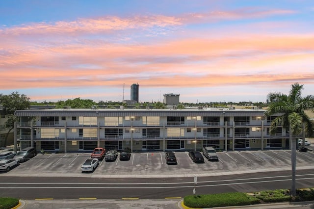 property at dusk with uncovered parking