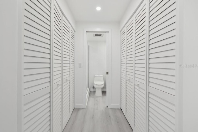 hall featuring recessed lighting, light wood finished floors, and visible vents