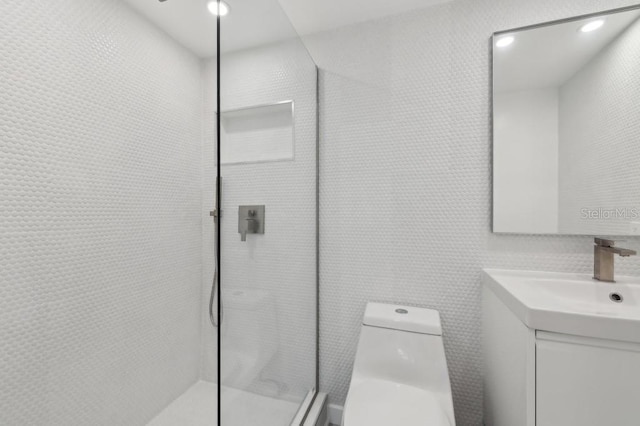 full bathroom featuring toilet, walk in shower, and vanity