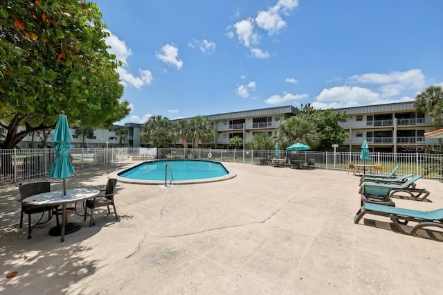 pool featuring a patio area and fence