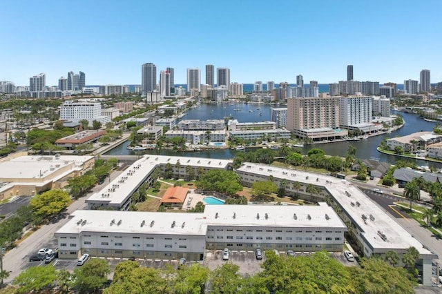drone / aerial view featuring a view of city and a water view