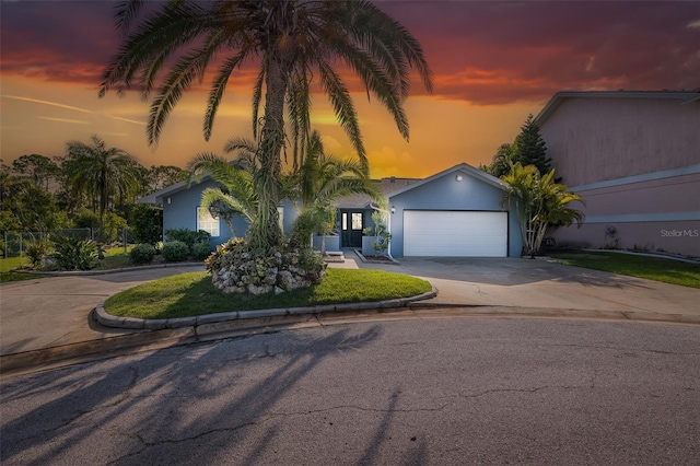 view of front of house featuring concrete driveway, stucco siding, and a garage