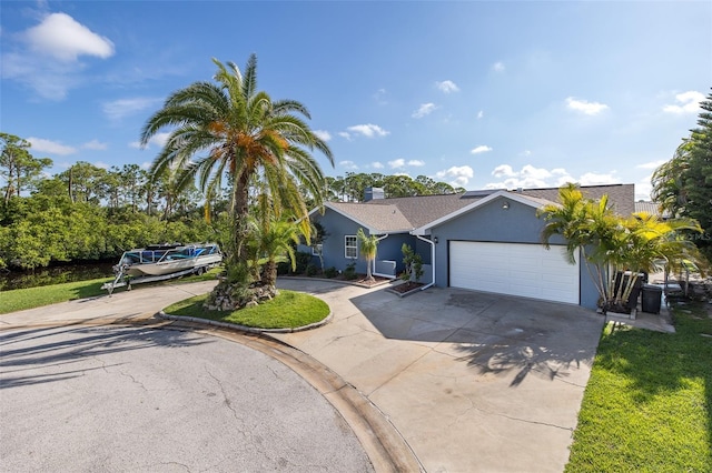 ranch-style house featuring an attached garage, driveway, and stucco siding
