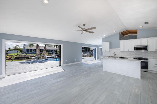 kitchen featuring visible vents, open floor plan, appliances with stainless steel finishes, and white cabinets