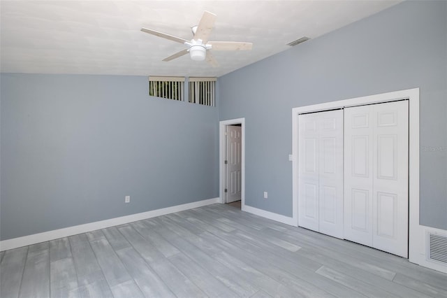unfurnished bedroom with ceiling fan, baseboards, wood finished floors, visible vents, and a closet