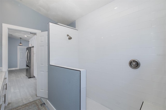 bathroom with baseboards and walk in shower