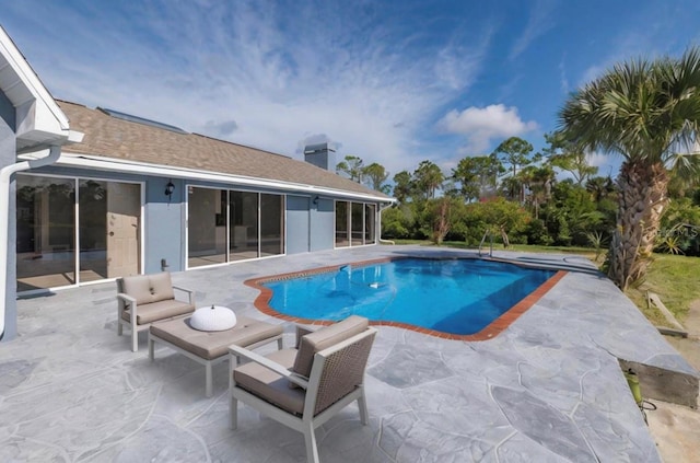 outdoor pool with a patio area