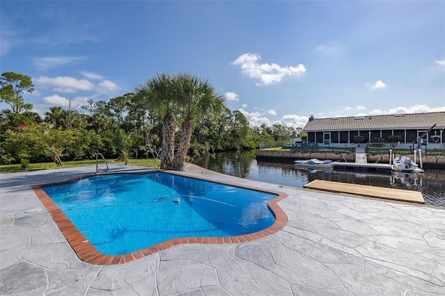 pool with a patio and a water view