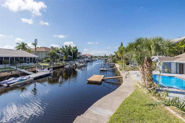 dock area featuring a water view and an outdoor pool
