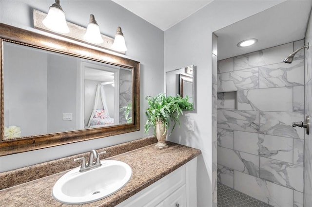 full bath with vanity and a tile shower