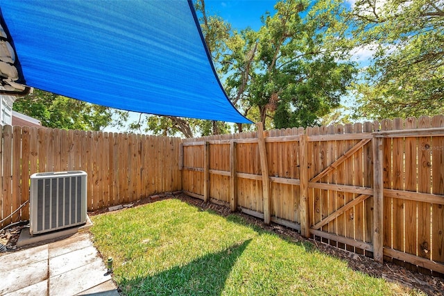 view of yard featuring central AC unit and a fenced backyard