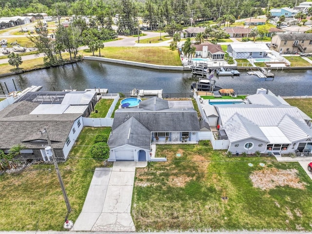 birds eye view of property with a water view and a residential view