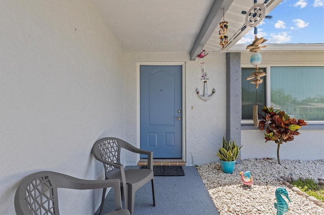 view of exterior entry with stucco siding
