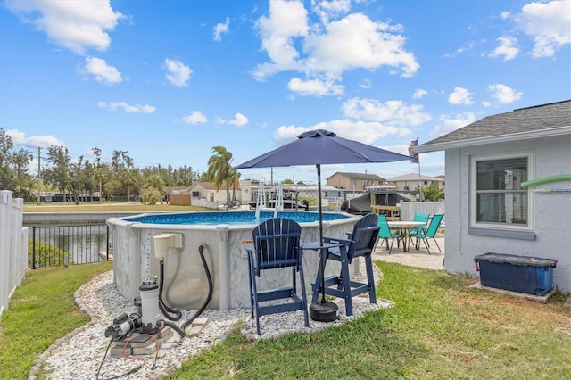 view of swimming pool featuring a lawn, a fenced in pool, fence private yard, and a patio area