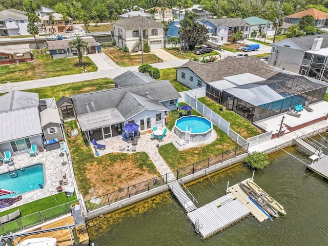 birds eye view of property featuring a water view and a residential view